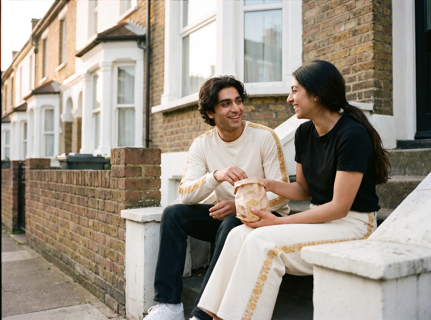 Two friends on a rooftop at dusk in the Marigold Long Sleeve and Trouser