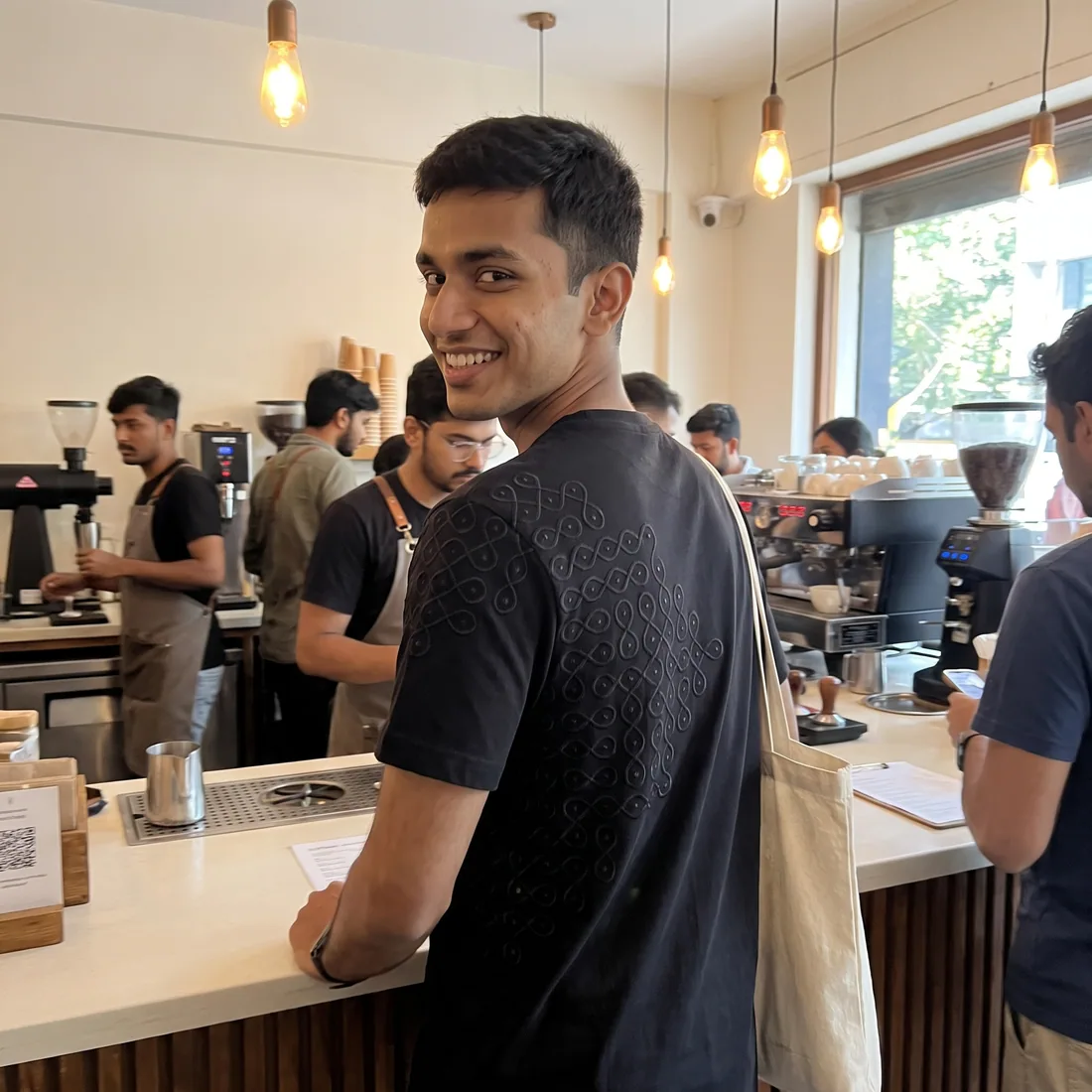 A customer in the Kolam Tee at a coffee shop counter