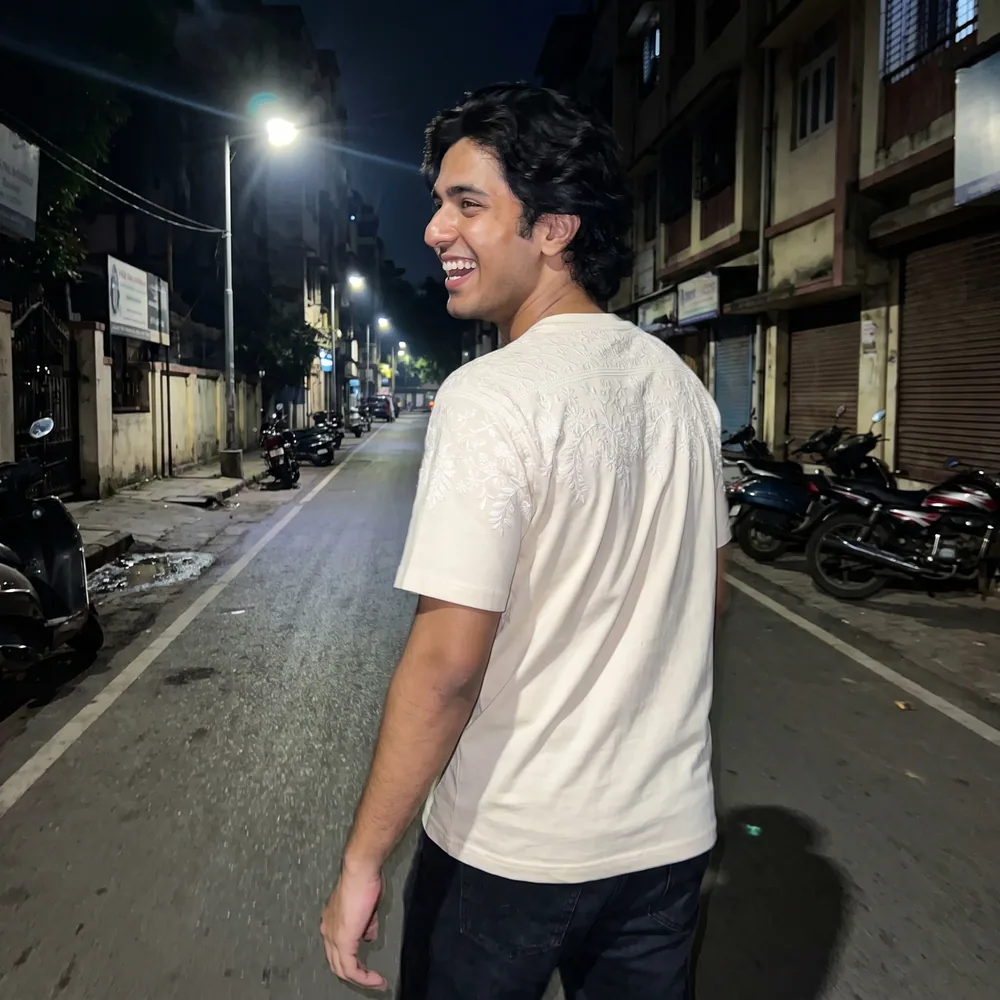 A customer in the Chikankari Tee on a side street at night